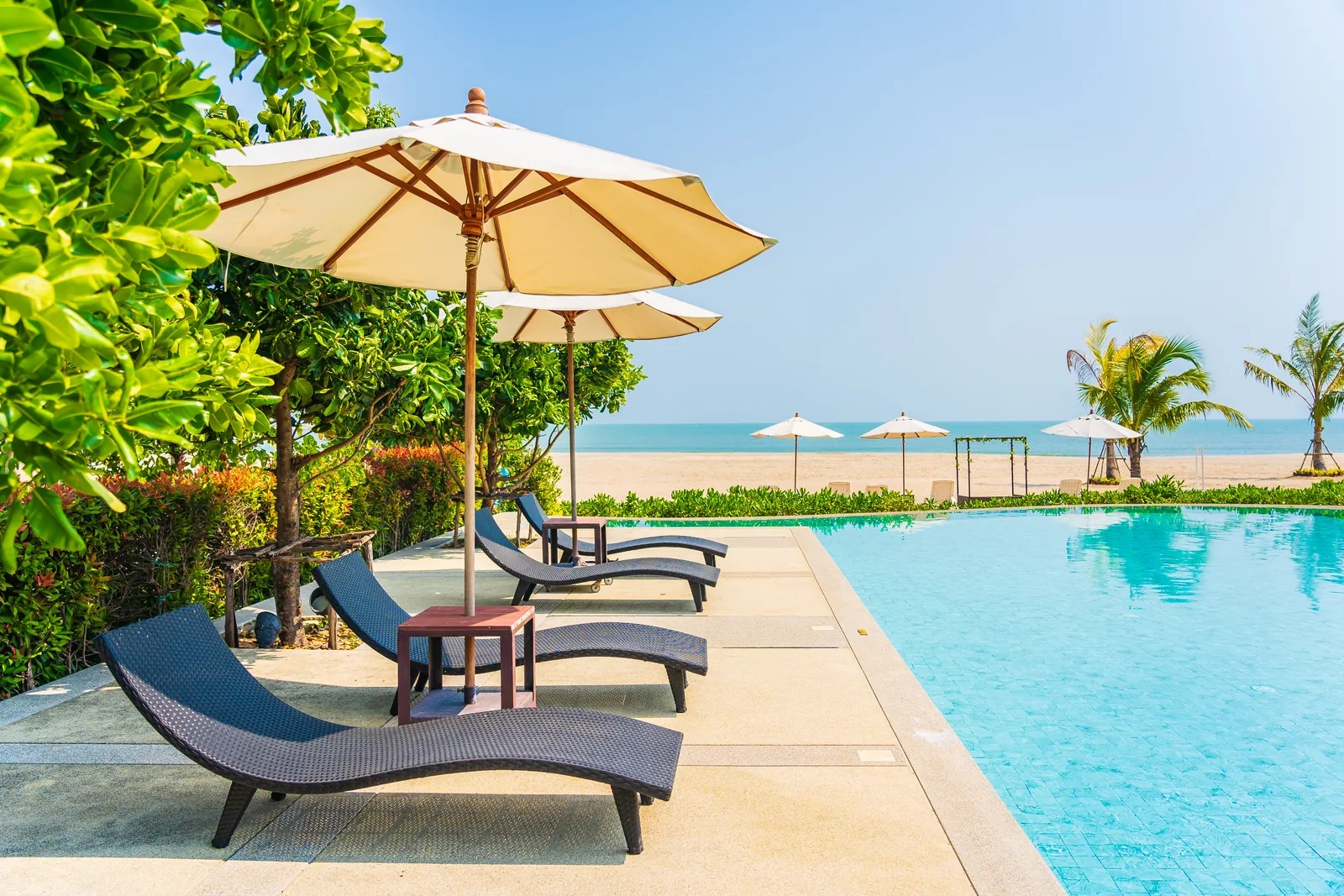 Representative tropical island beach with resort loungers