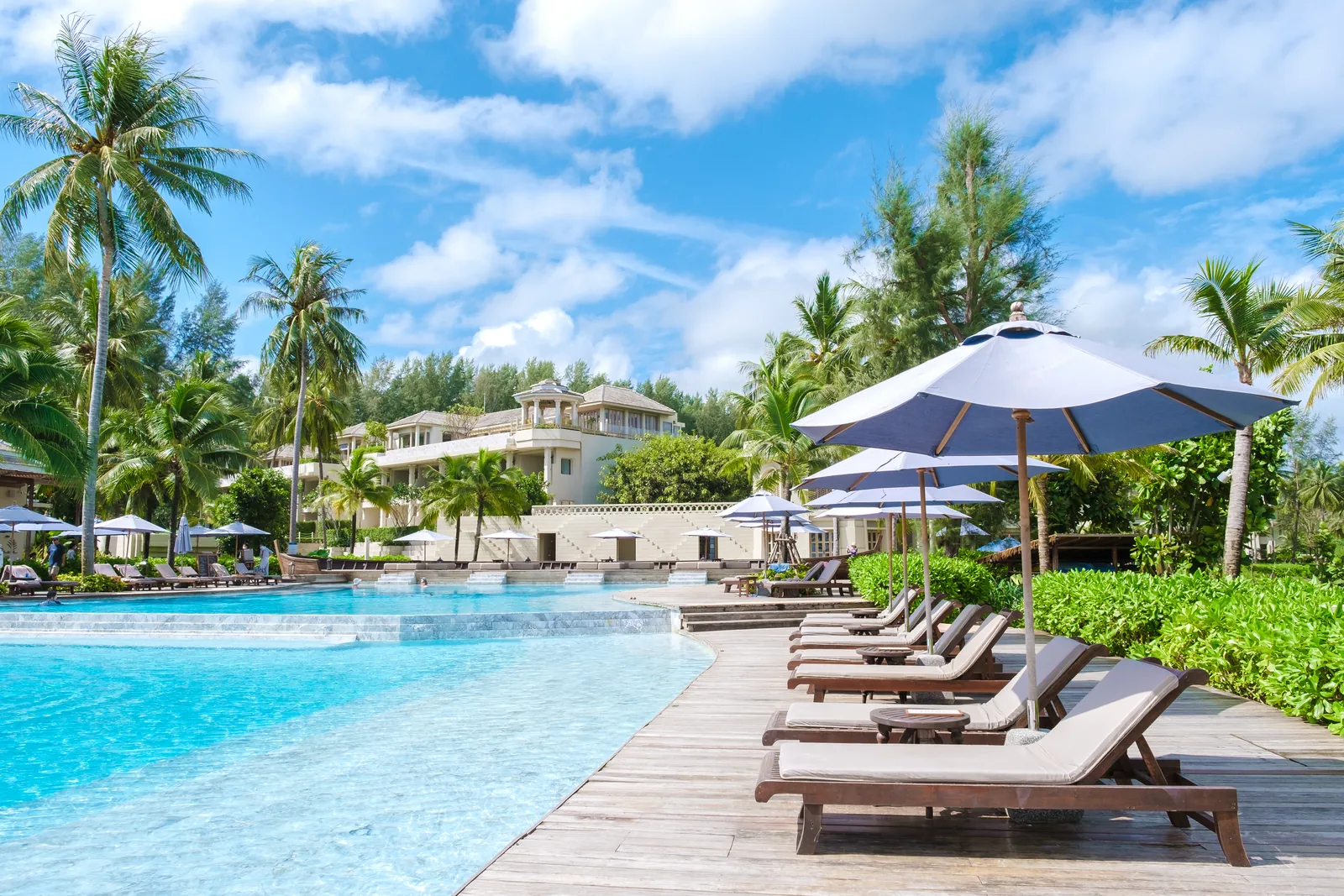 Swimming pool and loungers at a beach hotel